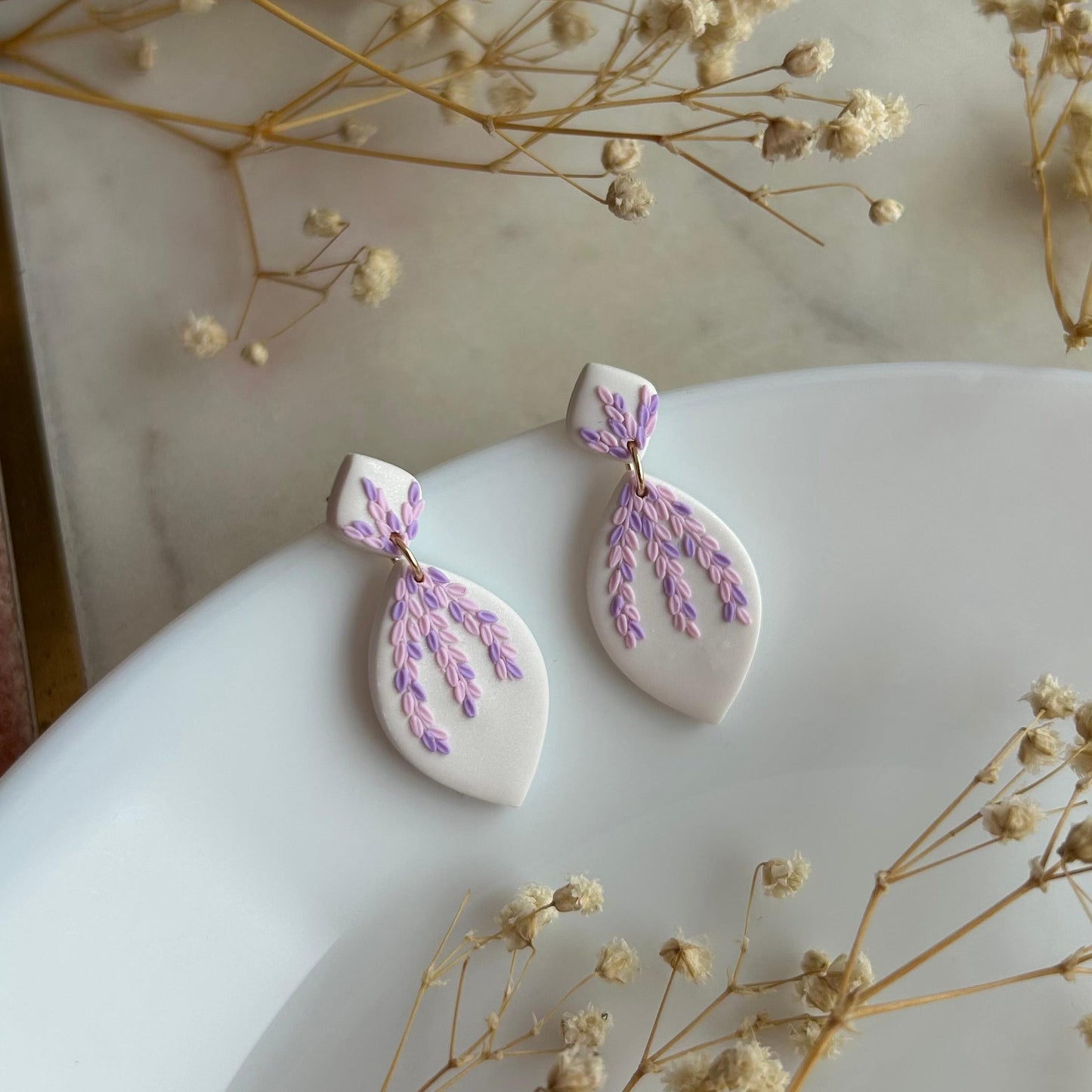 Tiny pink and purple leaves dangles